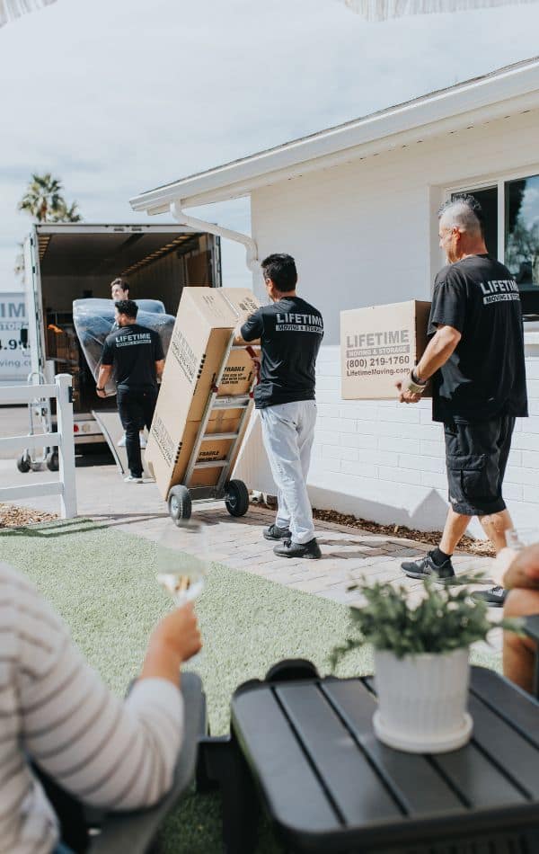 Lifetime Moving & Storage team in uniform preparing boxes for a home move