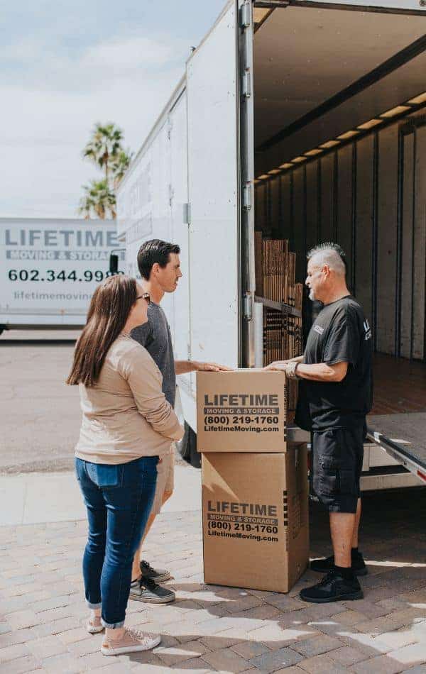Lifetime Moving & Storage team coordinating a residential move with multiple boxes