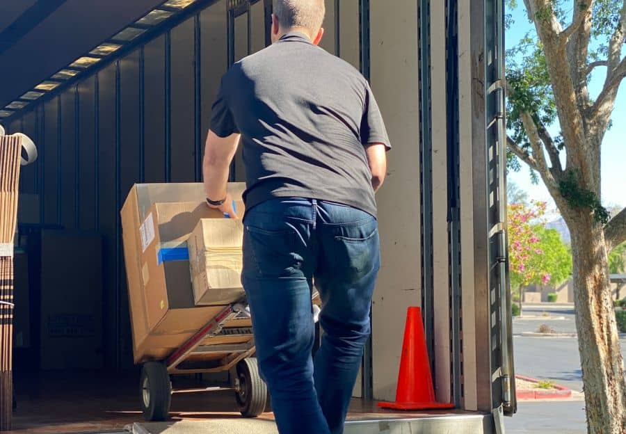 Lifetime Moving & Storage professional carefully packing a box for transport