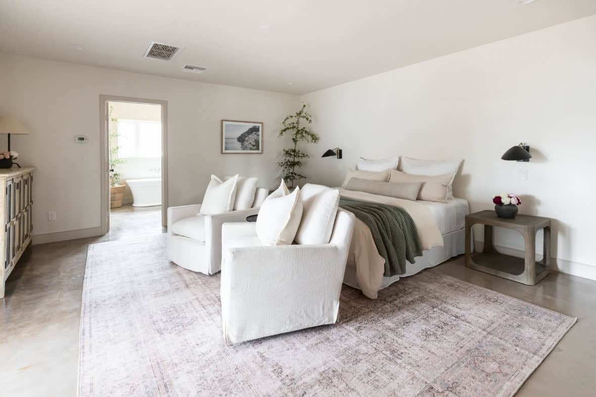 Vacant bedroom staged with neutral furnishings and soft lighting by Staging by Lifetime