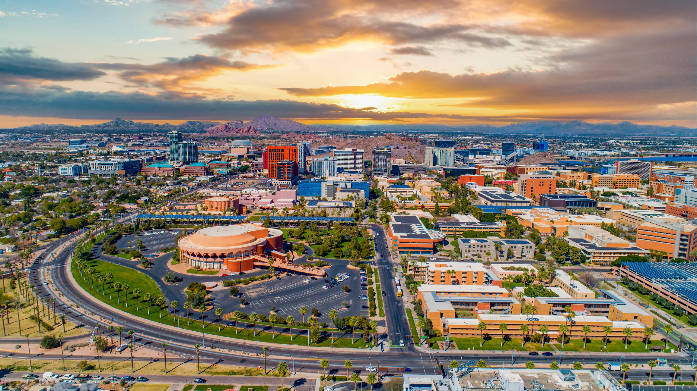 Phoenix Arizona city skyline at sunset with mountain views